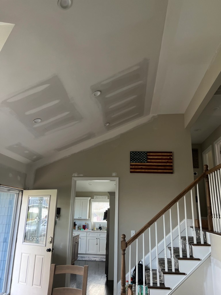 Vaulted ceiling and tall wall prepped with compound before interior painting