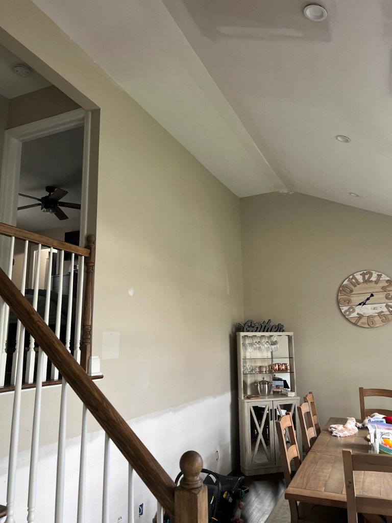 Sloped vaulted ceiling with compound stripes around recessed lights, ready for painting