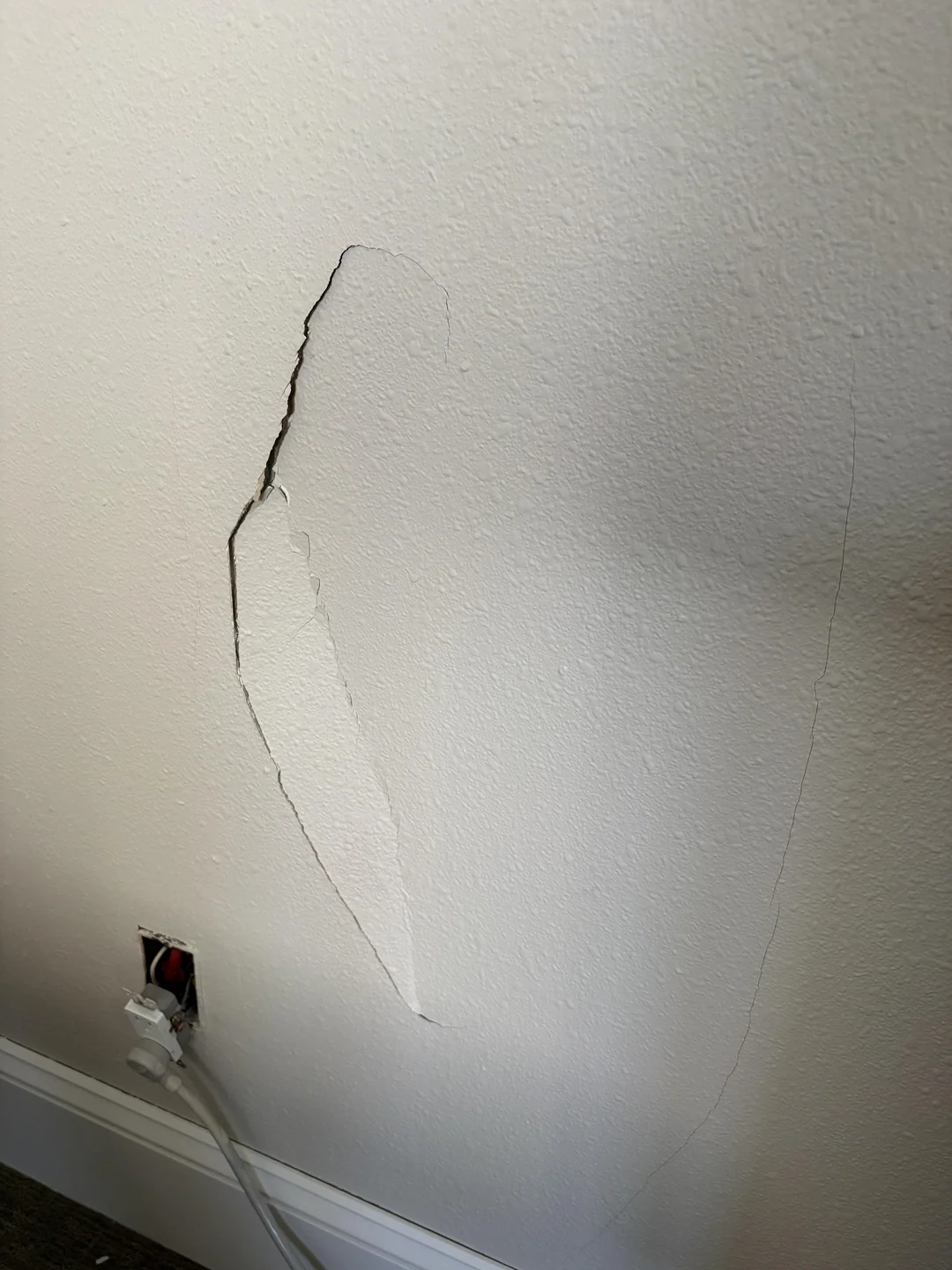 Large hole in drywall that needs patching before painting